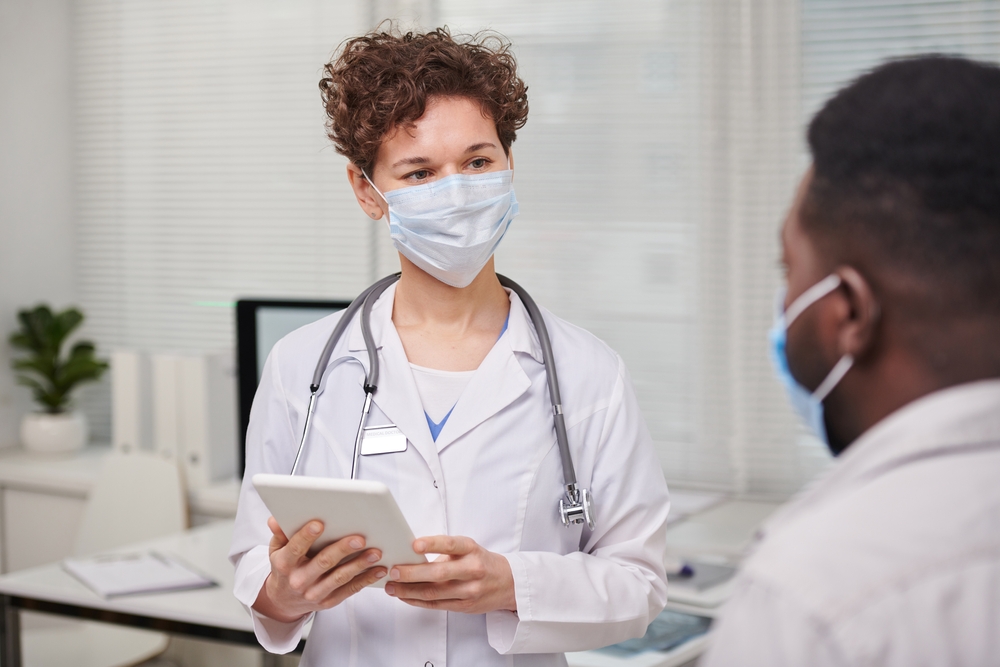 Nurse practitioner using clinical skills with patient