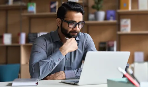 Higher education Ed.D. student studying at his laptop