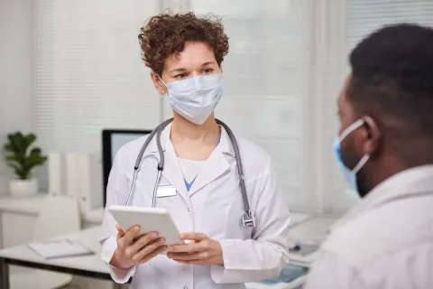Nurse practitioner using clinical skills with patient